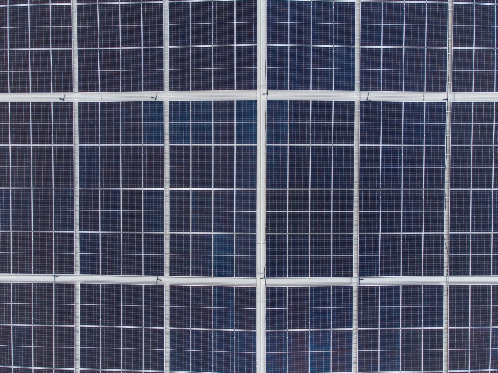 Solar panels on a house roof, aerial view